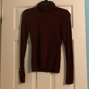 Maroon turtleneck with gold buttons on sleeves